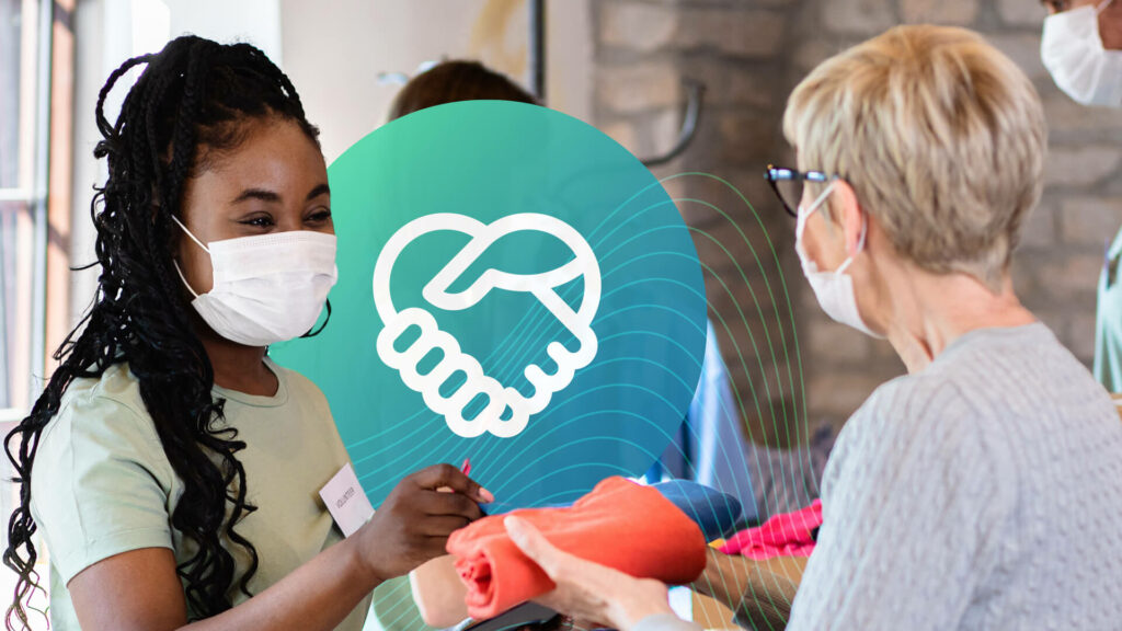 Two women wearing white face masks working together as humanitarian influencers