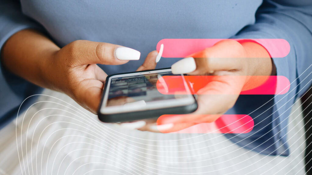 A woman's hands and long white nails are shown typing on a phone screen