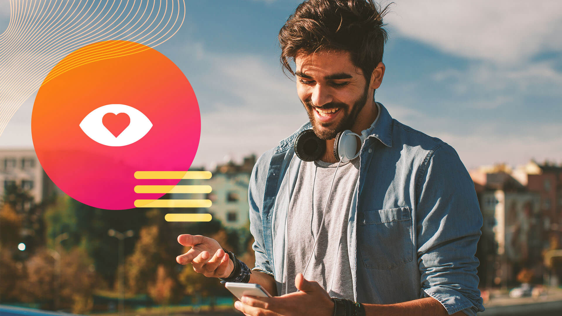 A male social media influencer smiles as he looks at his phone