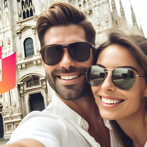 A couple wearing sunglasses pose for a selfie