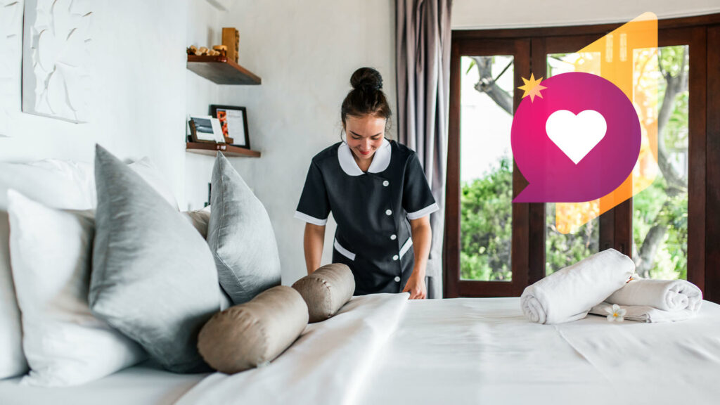 A housekeeper makes a hotel bed