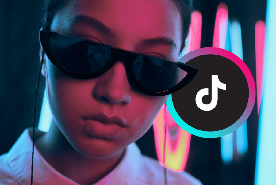 A woman wears black sunglasses; Tiktok logo on the right
