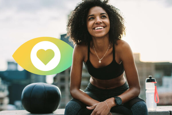 A woman sits next to a water bottle with a city view in the backgroun