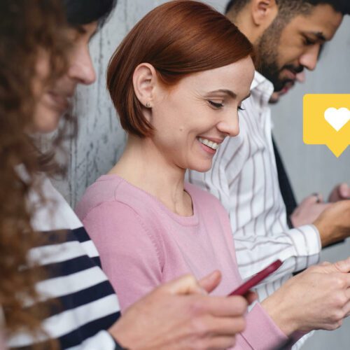 A group of people look at social media apps on their phones