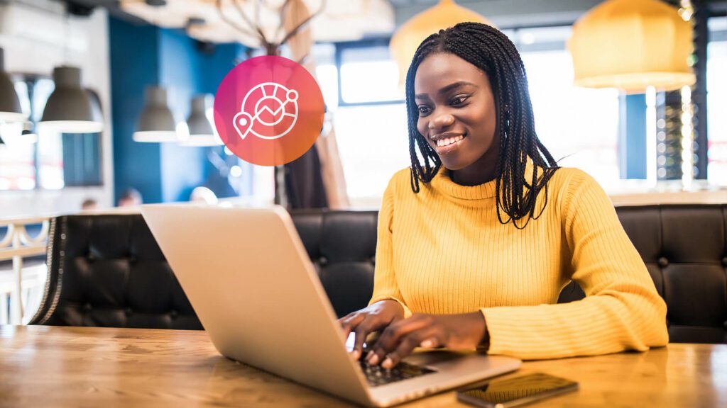 A content creator types on her laptop