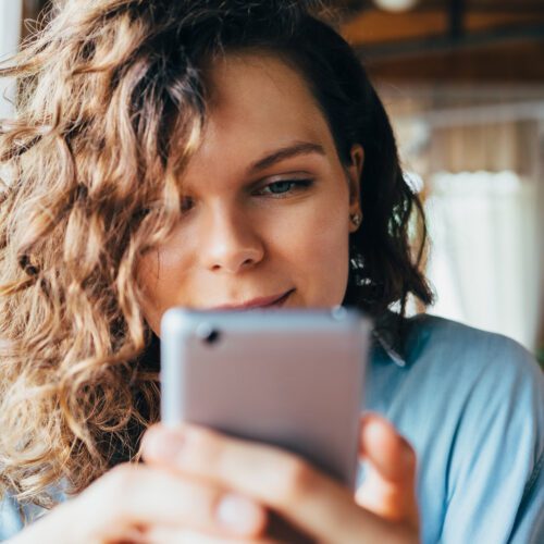 A woman looks at her phone