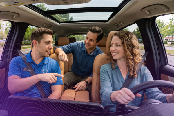 Couple going on a test drive with a Mazda sales person